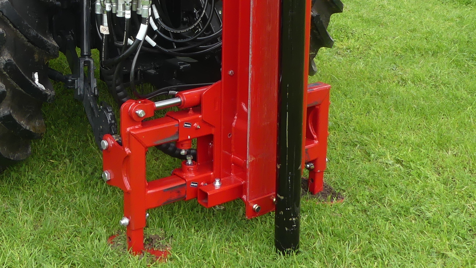 Kinghitter Series 2 post driver mounted to rear of tractor with mast shift and rock spike