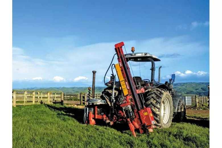 Expander rammer by new wooden sheep yards mountains in view